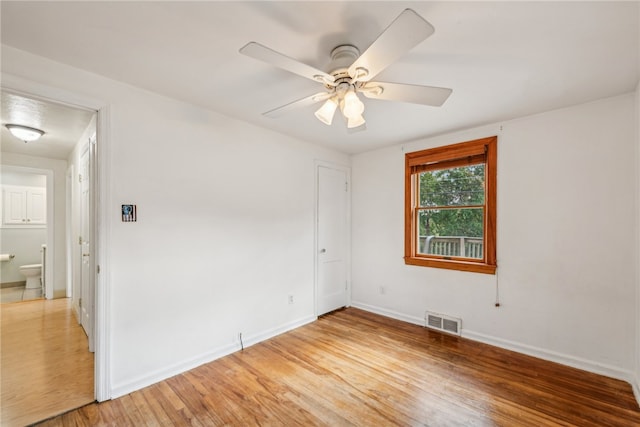 unfurnished room featuring ceiling fan and hardwood / wood-style floors