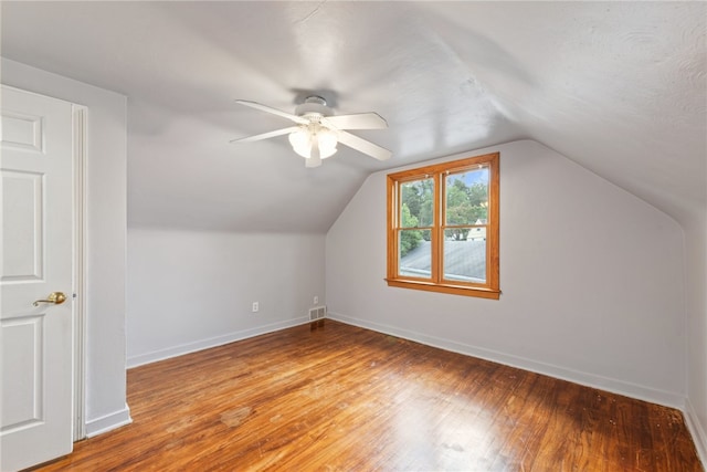 bonus room featuring ceiling fan, hardwood / wood-style flooring, and vaulted ceiling