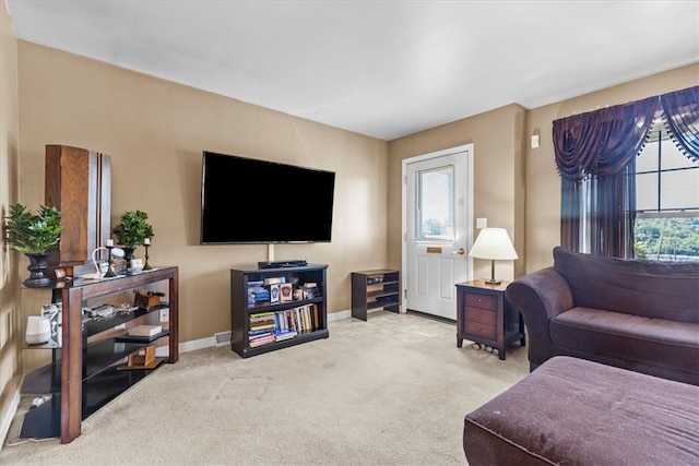 carpeted living room featuring plenty of natural light