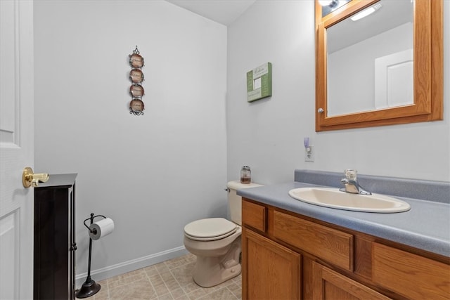 bathroom featuring tile patterned floors, vanity, and toilet