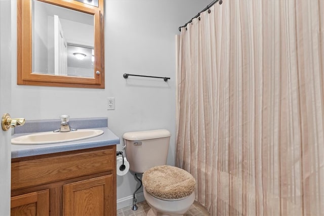 bathroom with walk in shower, vanity, tile patterned flooring, and toilet