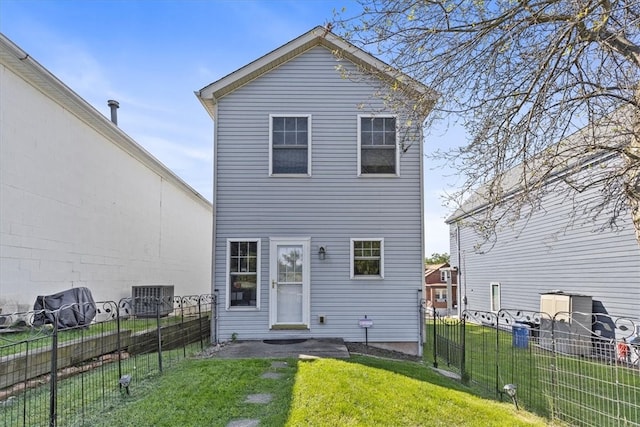 back of house with a yard and central air condition unit