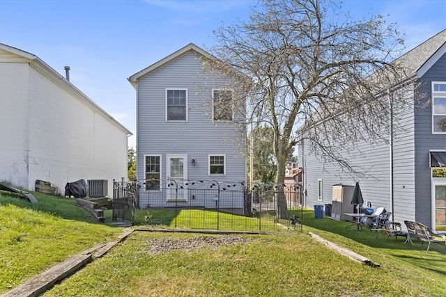 rear view of property featuring a lawn