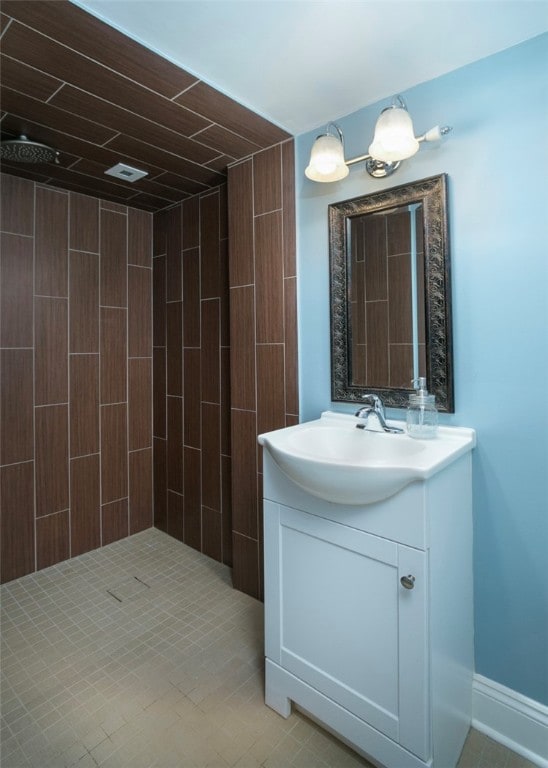 bathroom with vanity and tiled shower