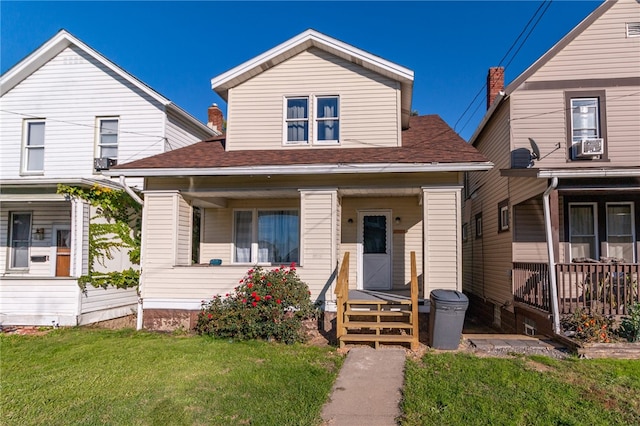 view of front of property with covered porch and a front yard