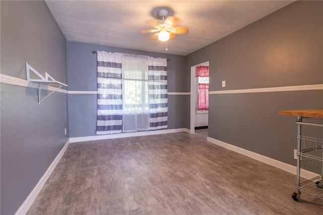 empty room with ceiling fan, plenty of natural light, and hardwood / wood-style floors