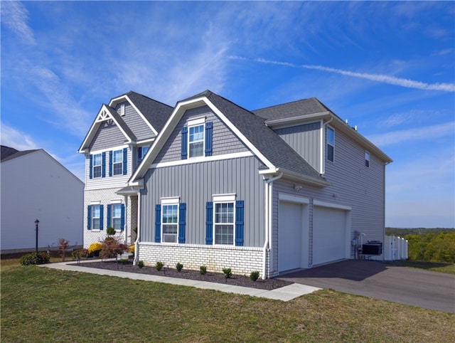 view of front of home with a garage and a front lawn