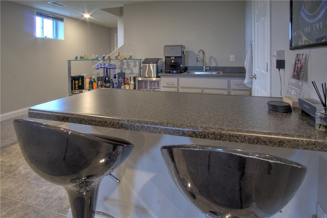 kitchen featuring sink and light tile patterned floors