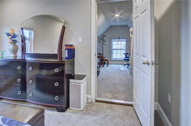 bedroom featuring light carpet and vaulted ceiling