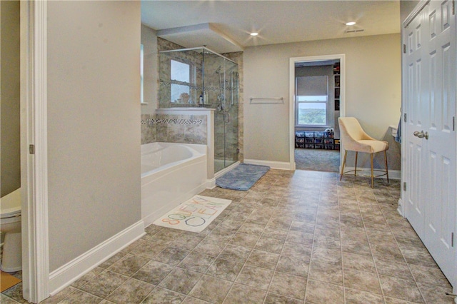 bathroom with independent shower and bath and tile patterned flooring