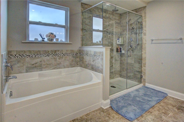 bathroom featuring tile patterned floors and independent shower and bath