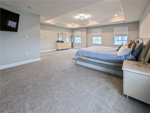 carpeted bedroom with a tray ceiling