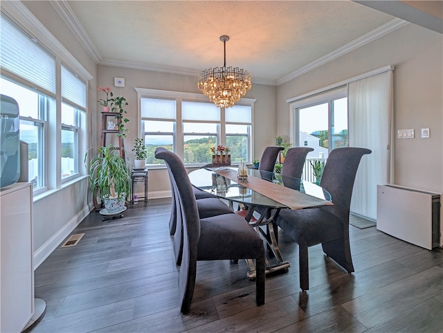 dining space with crown molding, a wealth of natural light, an inviting chandelier, and dark hardwood / wood-style flooring