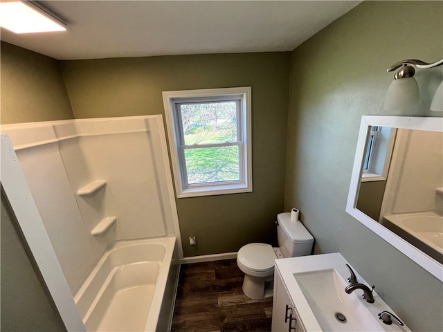 bathroom with toilet, hardwood / wood-style flooring, and vanity