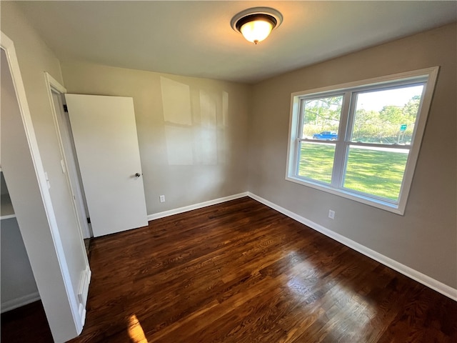 unfurnished room with dark hardwood / wood-style floors