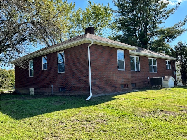 view of side of home with a yard