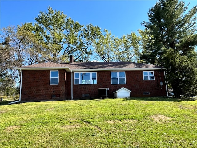 rear view of property featuring a yard