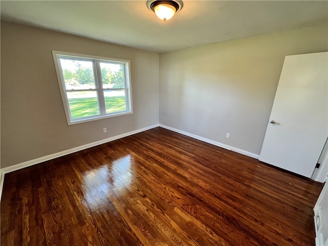 spare room with dark hardwood / wood-style flooring