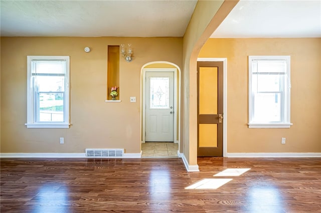 foyer entrance with wood-type flooring and plenty of natural light