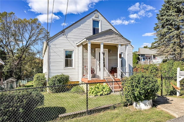 bungalow-style house featuring covered porch and a front lawn