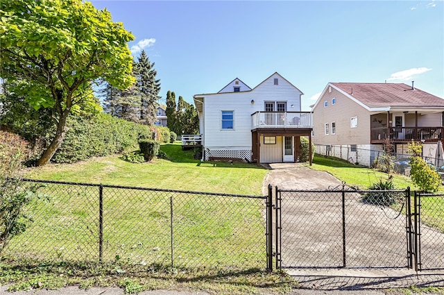 view of front of house with a front yard and a balcony