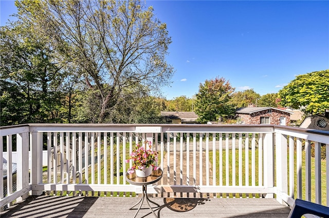 wooden terrace with a lawn