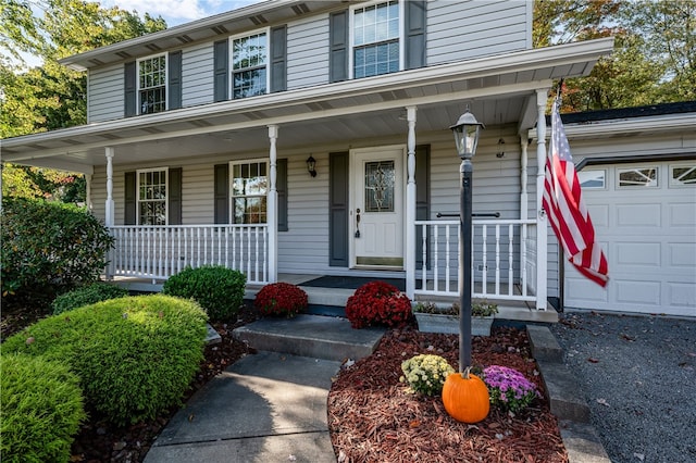 view of front of home with covered porch and a garage