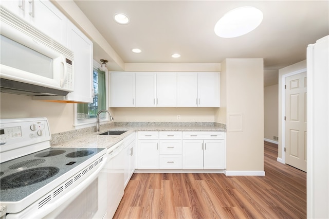 kitchen featuring sink, white cabinets, white appliances, and light hardwood / wood-style flooring