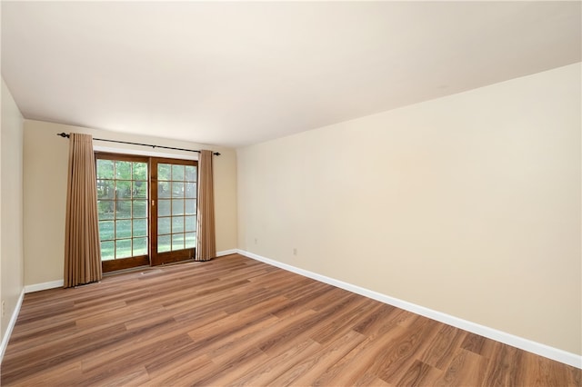 spare room with wood-type flooring