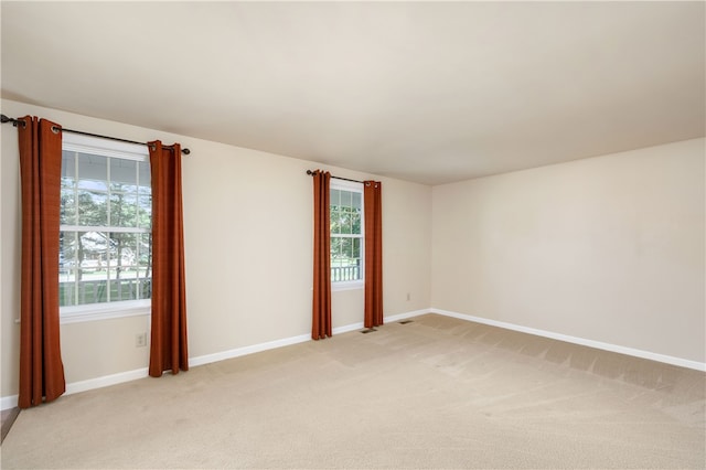 empty room featuring light colored carpet