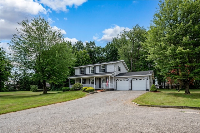 view of front of home featuring a front yard, a porch, and a garage