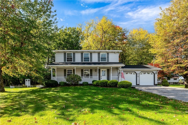 view of front of property with a front lawn, a porch, and a garage