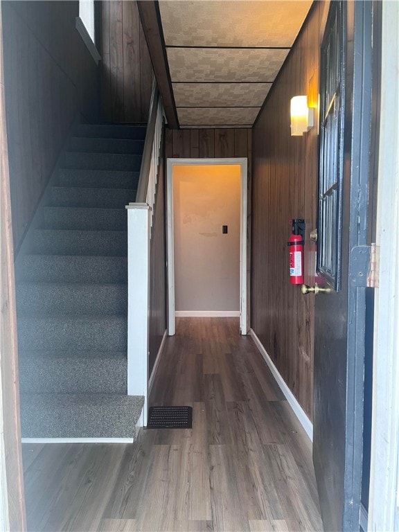 interior space featuring wooden walls and hardwood / wood-style floors