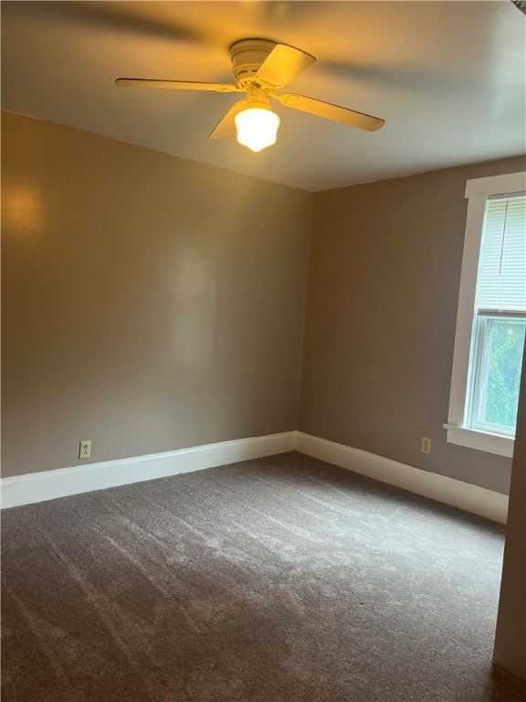 spare room with carpet floors and ceiling fan