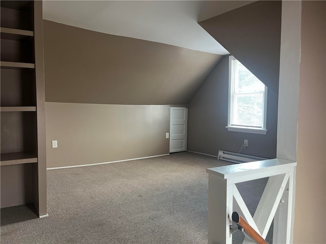 additional living space featuring lofted ceiling, a baseboard radiator, and carpet flooring