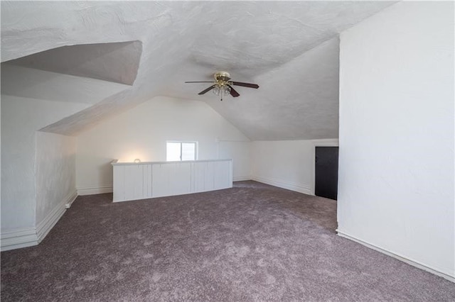 bonus room with carpet floors, vaulted ceiling, and ceiling fan