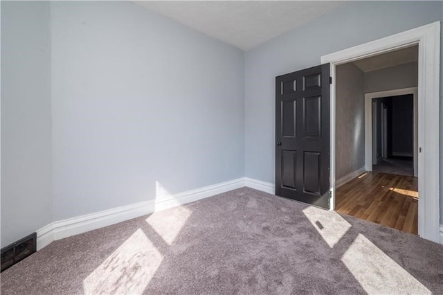 unfurnished room featuring dark wood-type flooring