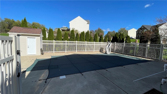 view of swimming pool with a patio area and an outbuilding