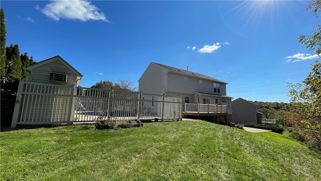 rear view of property with a yard and a wooden deck