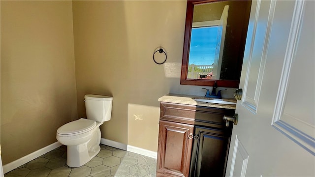 bathroom with tile patterned floors, toilet, and vanity