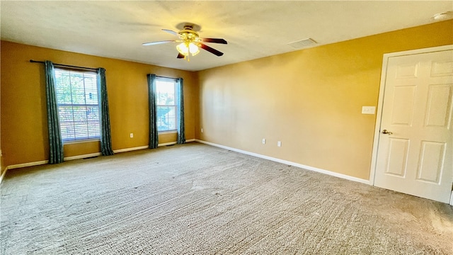 carpeted spare room with ceiling fan