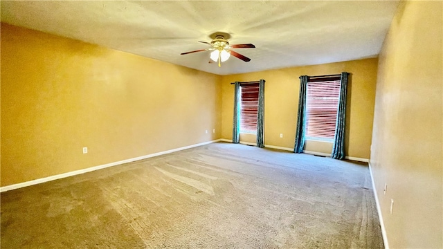 unfurnished room with carpet flooring and ceiling fan