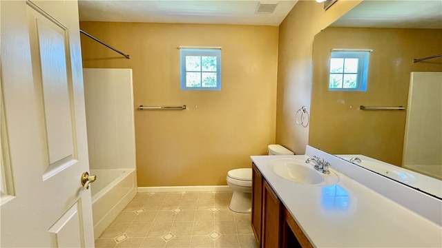 full bathroom featuring vanity, tile patterned flooring, toilet, and a wealth of natural light