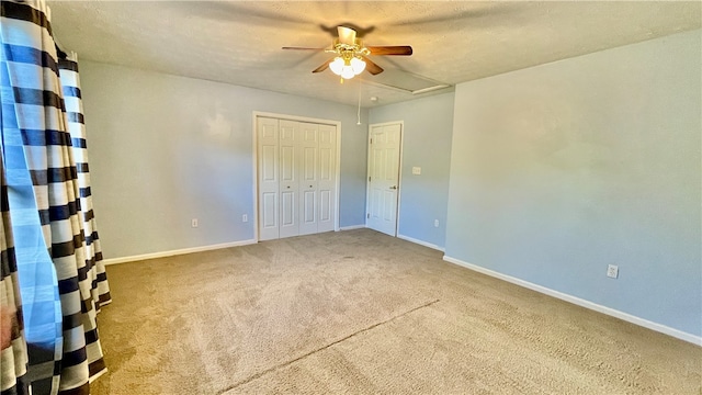 spare room featuring ceiling fan, carpet, and a textured ceiling