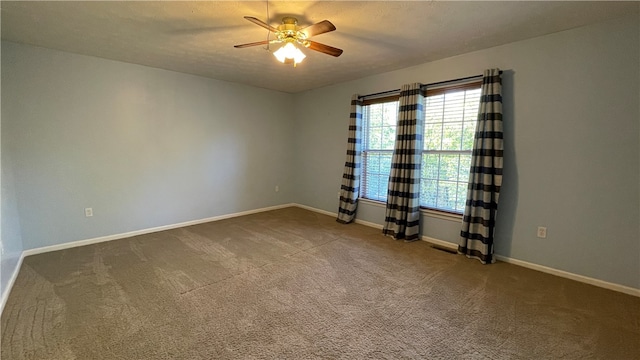 empty room featuring ceiling fan, a textured ceiling, and carpet