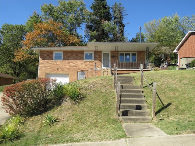 view of front facade featuring a porch, a front yard, and a garage