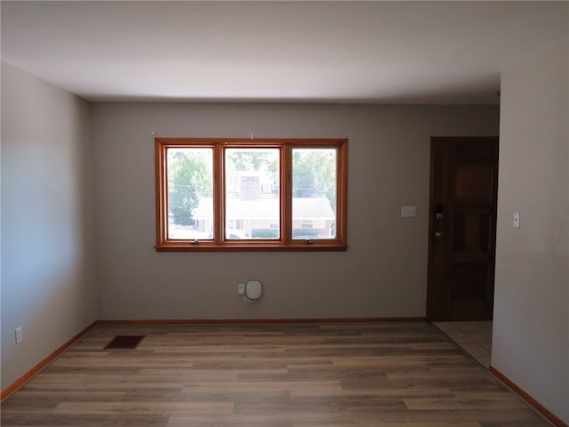 unfurnished room featuring wood-type flooring