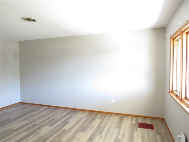 spare room featuring light hardwood / wood-style flooring