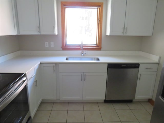 kitchen with light tile patterned floors, white cabinetry, sink, and stainless steel appliances