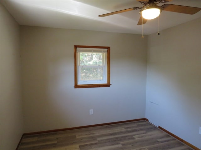 spare room featuring ceiling fan and dark hardwood / wood-style floors